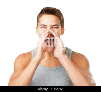Young man wearing a gray T-shirt shouting through hands isolated on white background Stock Photo