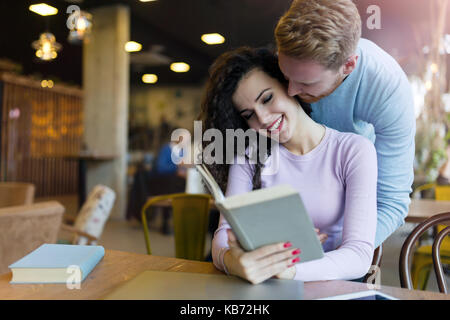 Happy young couple having fun in coffee shop Stock Photo