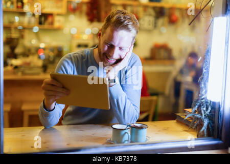 Handsome man using digital tablet in coffee shop Stock Photo