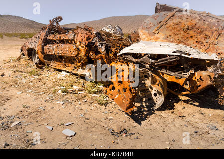 Abandoned Rusted Car with Bullet Holes in Desert Field Stock Photo - Alamy