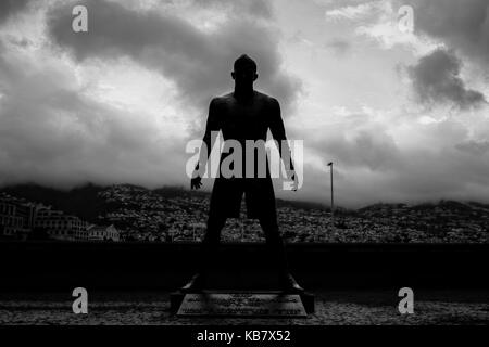 FUNCHAL, MADEIRA, PORTUGAL - APRIL 25, 2017: The statue of Christiano Ronaldo in front of CR7 museum, Funchal, Madeira. Dramatic evening lighting. Stock Photo