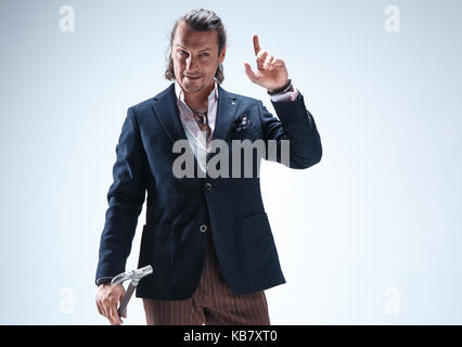 The mature barded man in a suit holding cane. Stock Photo