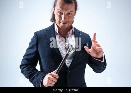 The mature barded man in a suit holding cane. Stock Photo