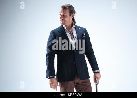 The mature barded man in a suit holding cane. Stock Photo