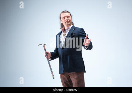 The mature barded man in a suit holding cane. Stock Photo