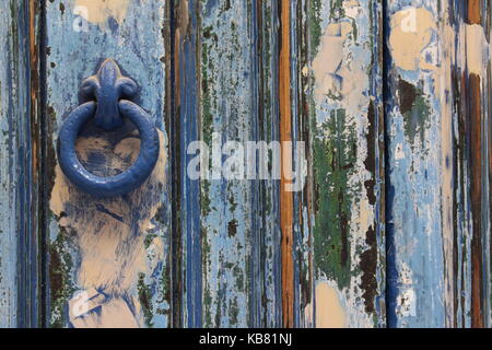 Background texture of faded, old, painted wooden door, blues and greens Stock Photo