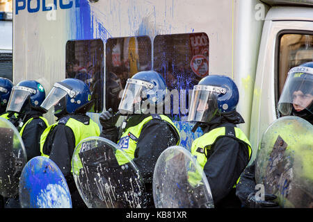 Metropolitan riot police officers carrying shields protect the Houses of  Parliament during student protests against tuition fees London 9/12/2010 Stock Photo