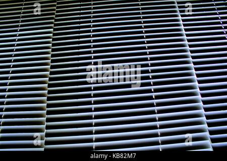 White aluminum horizontal blinds on the Windows closed. Stock Photo
