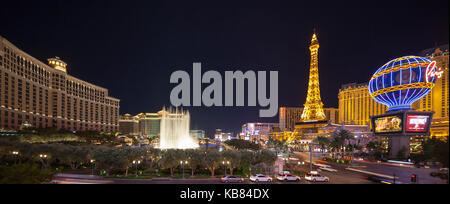 A skyline nighttime view of several casino's and resort on Las Vegas Blvd in Las Vegas, Nevada including the Fountains at Bellagio water show. Stock Photo