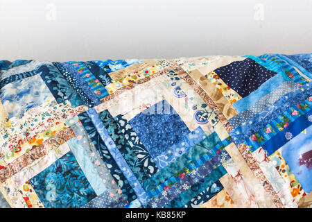 sewing, quilting, creation, culture, needlework concept - small long pieces of satin cloth with various patterns sewed in forms of squares in great co Stock Photo