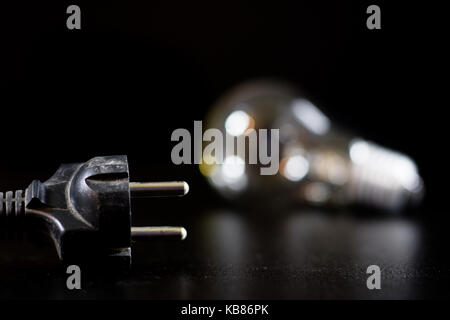 Old entangled cables, electronics and old cable connectors on a black table. Black background Stock Photo