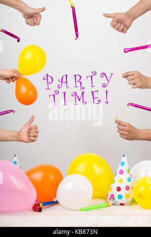 holidays, celebration, occasion concept. in the center there is inscription that says party time. and around in there are lots of thumbs up, colorful  Stock Photo