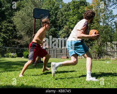 Brothers Playing Basketball Stock Photo