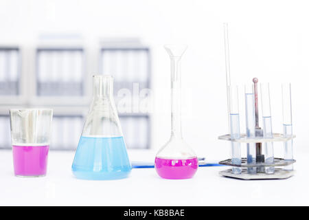 Chemical flasks with reagents isolated over white background. Stock Photo