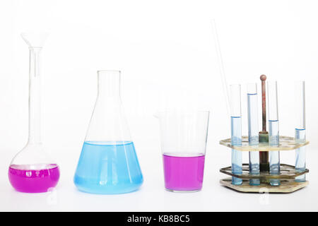 Chemical flasks with reagents isolated over white background. Stock Photo