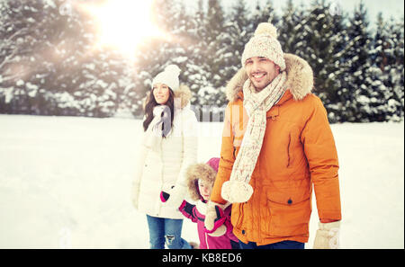 happy family in winter clothes walking outdoors Stock Photo