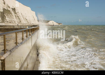 Rough sea with waves crashing onto seafront promenade at Rottingdean near Brighton, East Sussex, England Stock Photo