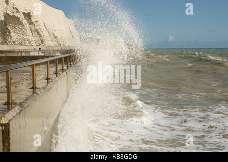 Rough sea with waves crashing onto seafront promenade at Rottingdean near Brighton, East Sussex, England Stock Photo