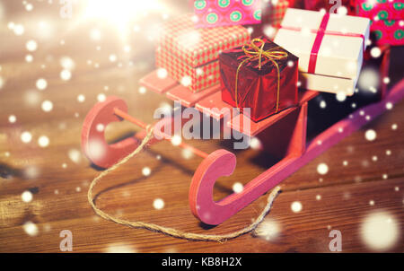 close up of christmas gift boxes on wooden sleigh Stock Photo