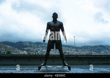 FUNCHAL, MADEIRA, PORTUGAL - APRIL 25, 2017: The statue of Christiano Ronaldo in front of CR7 museum, Funchal, Madeira. Dramatic evening lighting. Stock Photo