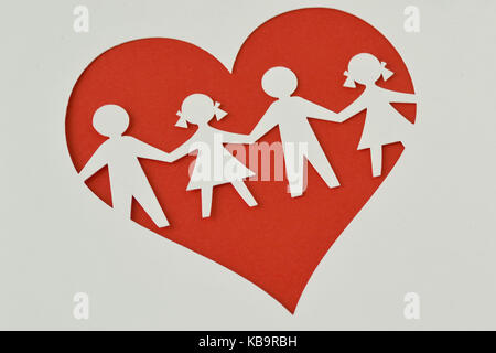 Paper silhouette cut of children chain in a heart - Child protection and love concept Stock Photo