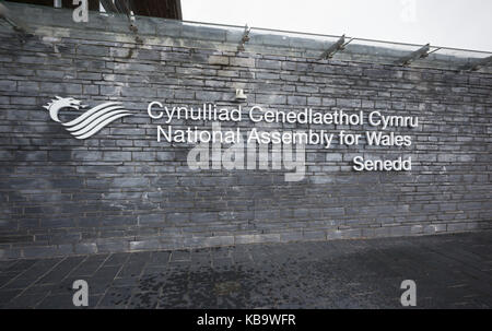 Bilingual National Assembly for Wales sign outside Senedd, with metal letters set into slate blocks. Cardiff, UK Stock Photo