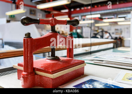 Manually operated printing press in a printer's workshop. Stock Photo