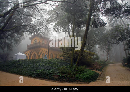 Chalet Garden and the Countess D'Edla (Chalet e Jardim da Condessa D'Edla) at Da Pena Palace and Park in Sintra, Portugal during wet, foggy weather Stock Photo