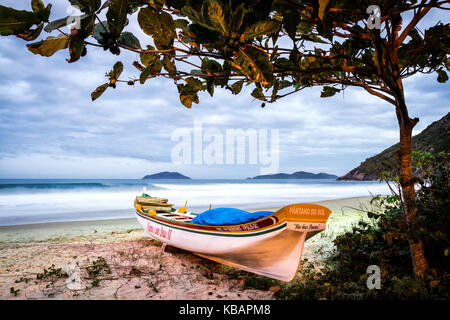 Boat on the sand at Solidao Beach at dusk. Florianopolis, Santa Catarina, Brazil. Stock Photo
