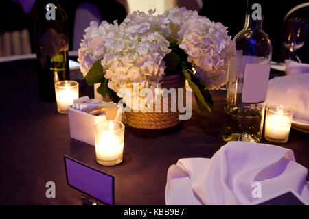 candlelit table setting with wine, flowers and wine glasses Stock Photo