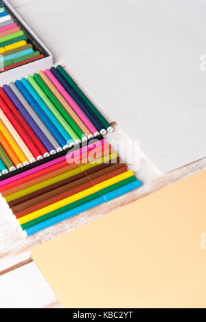 Top view of different colorful markers in boxes on white table Stock Photo