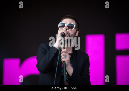 The English rock band Kasabian performs a live concert at the Orange Stage at the Danish music festival Roskilde Festival 2014. Here lead singer and songwriter Tom Meighan is pictured live on stage. Denmark, 06/07 2014. Stock Photo