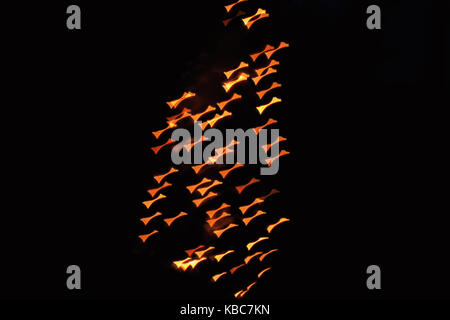 Abstract Close-Up Of Butterfly Shaped Bokeh Of Orange Christmas Lights Taken With Helios 44-2 Vintage Lens During Night Stock Photo