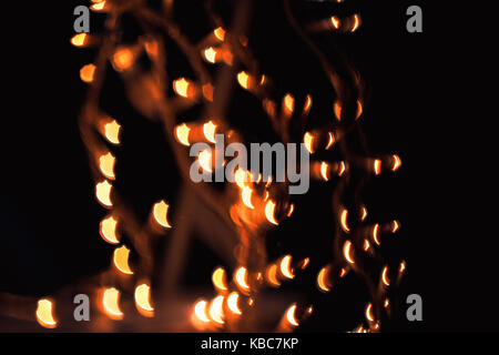 Abstract Close-Up Of Odd Shaped Bokeh Of Orange Christmas Lights Taken With Helios 44-2 Vintage Lens During Night Stock Photo