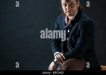 Businessman sitting on an armchair Stock Photo