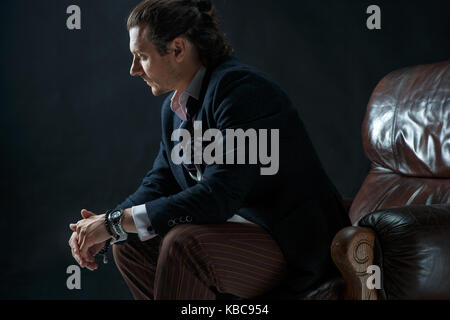 Businessman sitting on an armchair Stock Photo