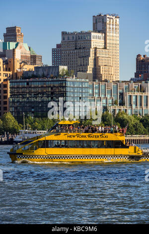 Brooklyn Bridge Park from the East River with a water taxi. Brooklyn, New York City Stock Photo