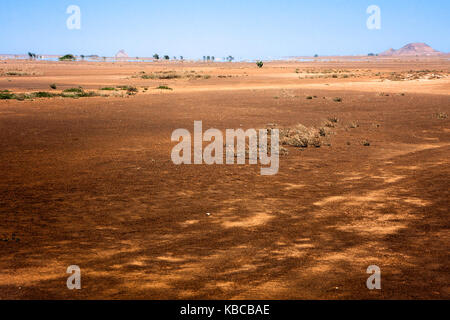 Empty flat desert fields in North  Sal Island, Cape Verde. Mirage at the horizon. Martian like landscape near Buracona Stock Photo