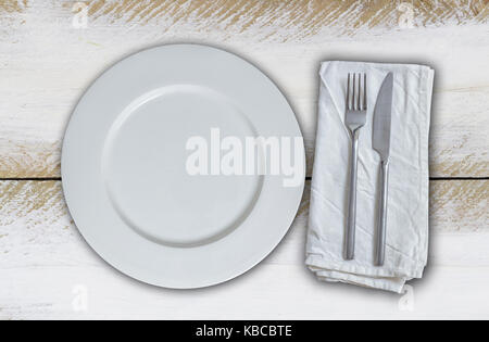 Empty plate and cutlery on olive-white wood. Stock Photo