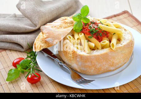 Pasta with tomato sauce filled in Italian ciabatta bread Stock Photo