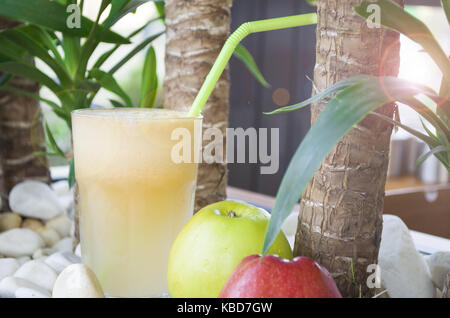 glass of apple juice and green apples on white stone background Stock Photo