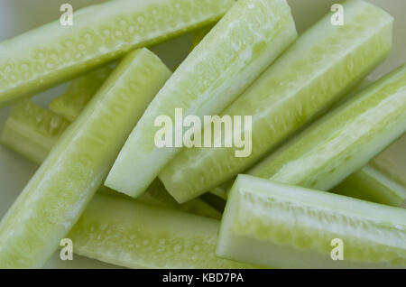heap of fresh sliced cucumbers on an old wooden table Stock Photo