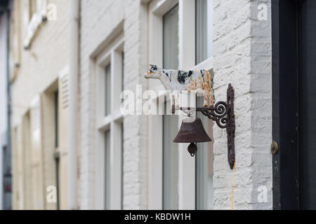 Antique brass bell on the back of the door and early doorbell