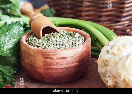 Dried celery leaves with fresh raw celery root, stalk and leaves Stock Photo