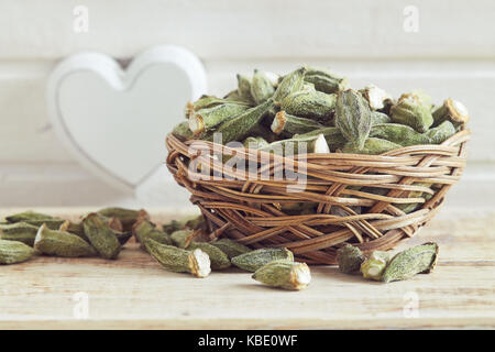 Dried okra (ladies' fingers, ochro) in woven basket Stock Photo