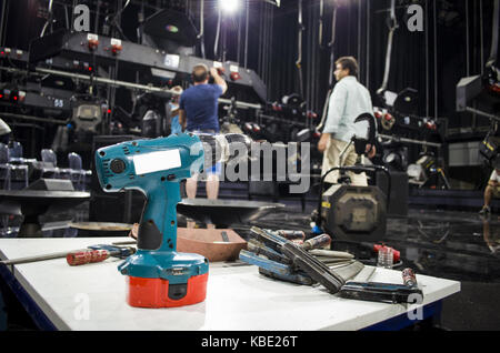Charged drills and tools are waiting to work on the table Stock Photo
