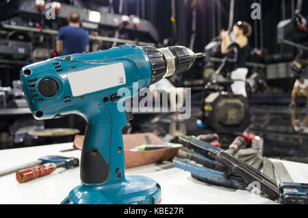 Charged drills and tools are waiting to work on the table Stock Photo