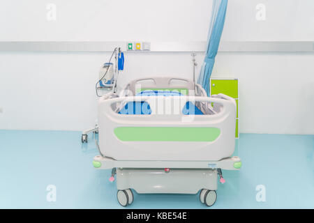 Empty hospital bed with medical equipment in Recovery Room in hospital. Concept of medical, sickness, death. Stock Photo