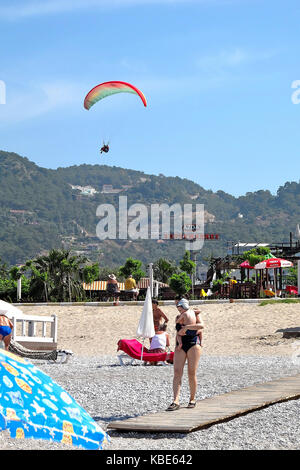 Para-glider landing in Olu Deniz town, Turkey Stock Photo