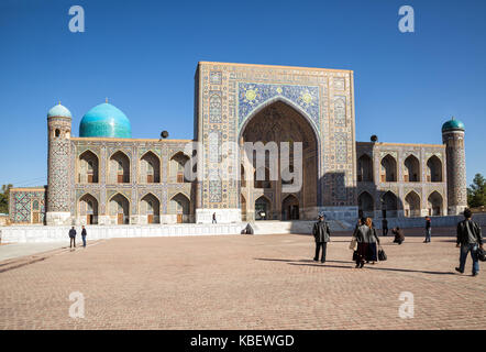 SAMARKAND, UZBEKISTAN - OCTOBER 15, 2016:  People on the Registan Square near Tilya Kori Madrasah Stock Photo